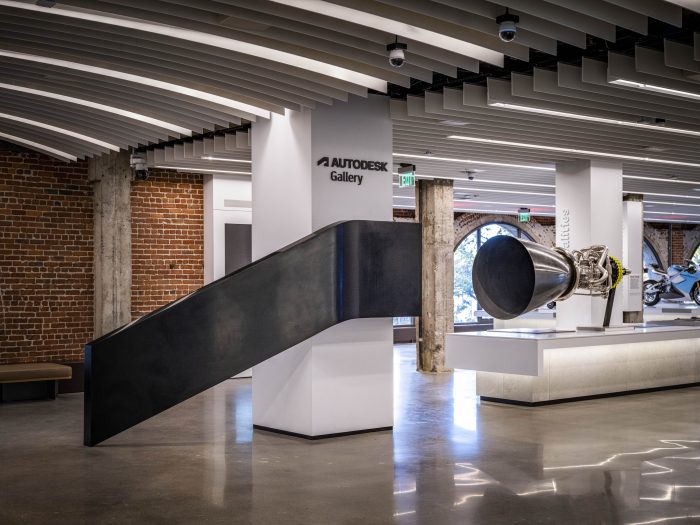 Exhibits on the Autodesk Gallery floor, including a jet engine and a motorcycle